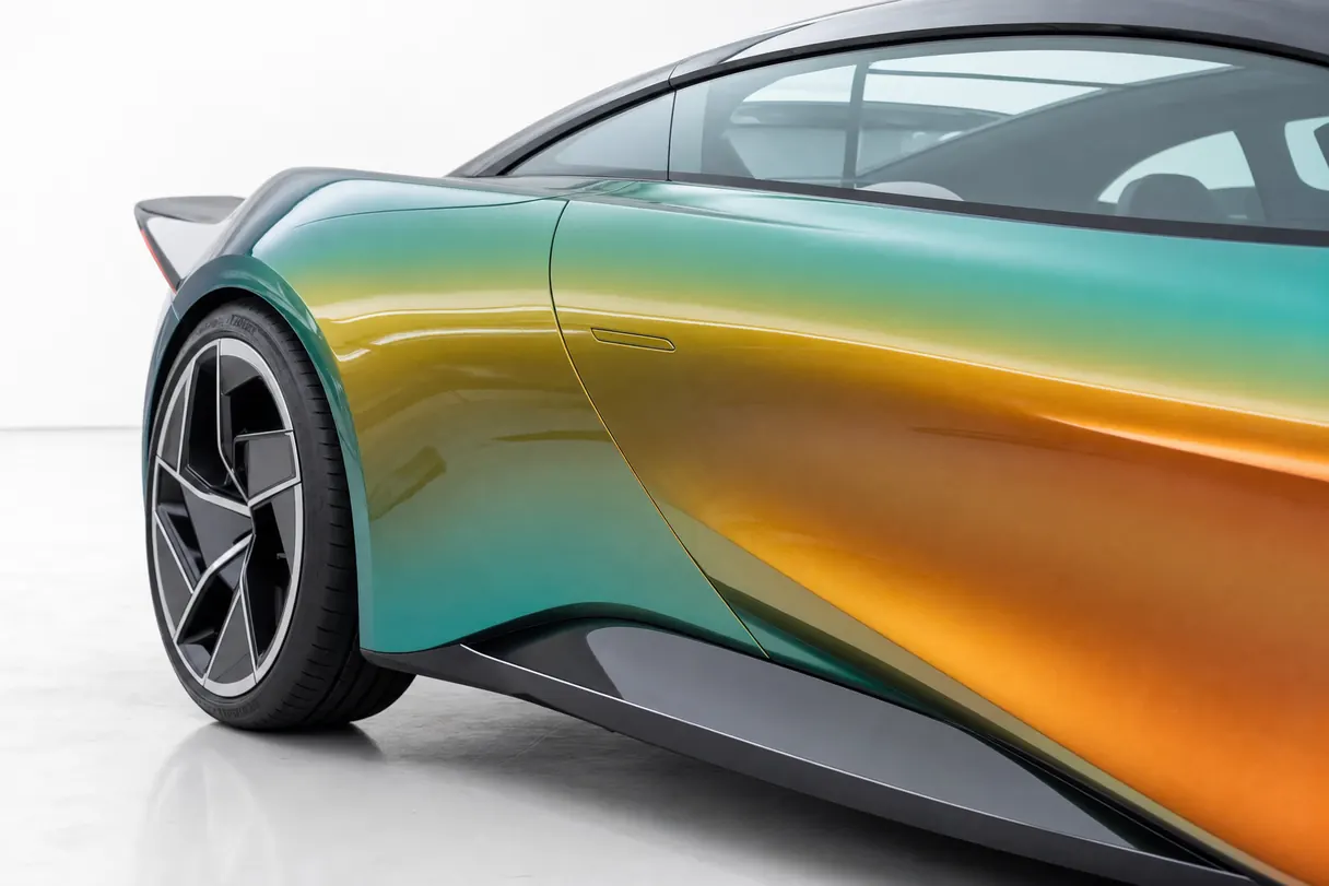 The rear haunch of a sports coupe in an iridescent teal-to-bronze colour-shift wrap